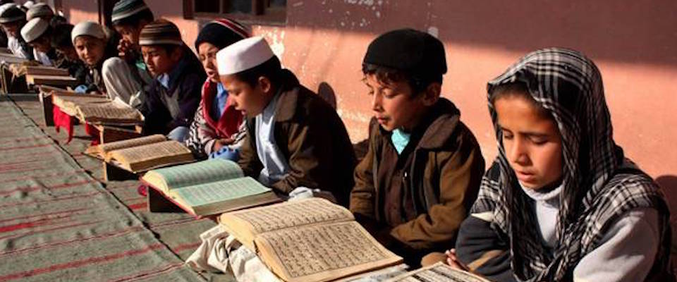 epa03591518 Afghan children learn to read the holy Koran, at a seminary in Jalalabad, Afghanistan, 20 Febuary 2013. Civilian deaths and injuries in the ongoing Afghan war have decreased for the first time in six years, the UN said in a report on 19 February.  EPA/S. SABAWOON