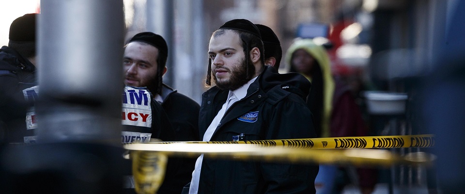 epa08063903 Members of the Hasidic Jewish community talk while standing in front of the kosher market which was the scene yesterday of multiple shooting in Jersey City, New Jersey, USA, 11 December 2019. Six people, including the two gunmen, were killed in shootings which started with a confrontation in a nearby cemetery, where a Jersey City police officer was killed, and culminated in a shootout with police from inside a kosher supermarket.  EPA/JUSTIN LANE