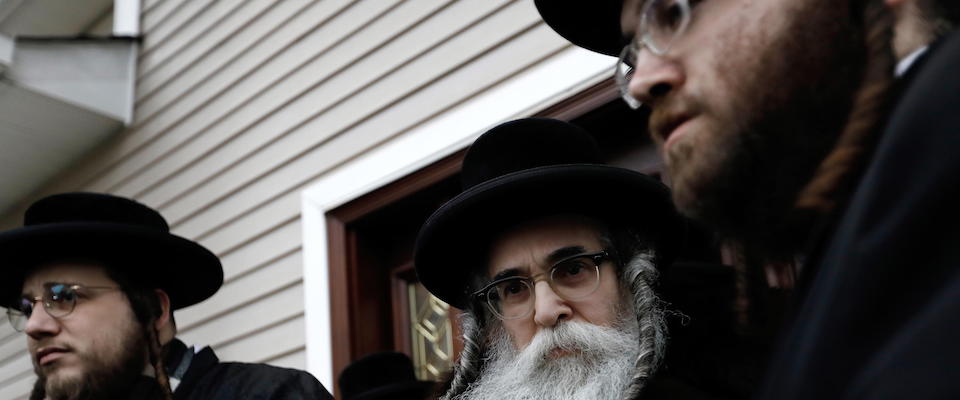 epa08094416 Hasidic rabbi Chaim Leibush Rottenberg, (C) leads Ultra-Orthodox Jews in the inauguration of a Torah scroll ceremony outside his home in Monsey, New York, USA, 29 December 2019. On 28 December an intruder with a large knife burst into the home of Hasidic rabbi Chaim Rottenberg in Monsey, New York an upstate suburb and stabbed and wounded five people during a Hanukkah candle lighting ceremony.  EPA/PETER FOLEY