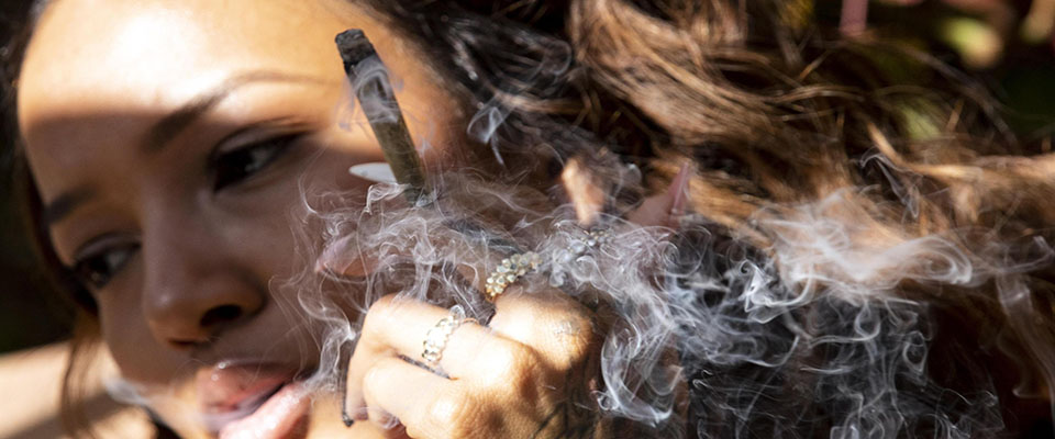 epa07887753 A customer smokes a joint in the patio at Lowell Cafe, the first cannabis cafe to open in the US, on opening day in Los Angeles, California, USA, 01 October 2019. Lowell Cafe is the first cannabis cafe in the US, it will serve food, coffee, pre-packaged edible cannabis, cannabis flowers and other products. California legalized the recreational use of cannabis in November 2016.  EPA/ETIENNE LAURENT  ATTENTION: This Image is part of a PHOTO SET