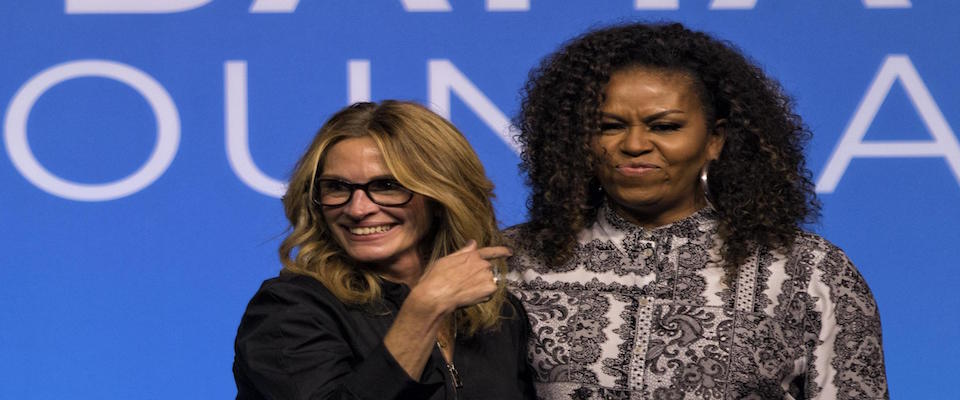 epa08064554 Former US first lady Michelle Obama (R) and US actress Julia Roberts at the end of an Obama Foundation event in Kuala Lumpur, Malaysia, 12 December 2019.  EPA/AHMAD YUSNI