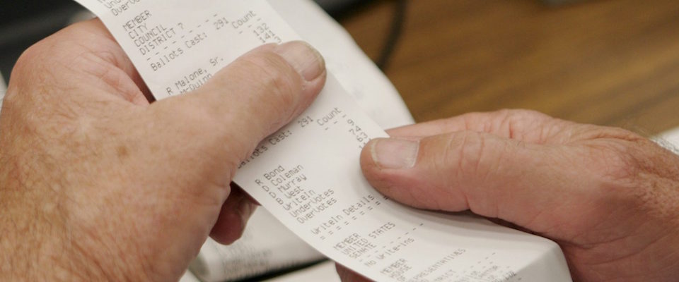 epa00858405 An election worker examines a receipt from an electronic voting machine at the City of Richmond Electoral Board office in Richmond, Virginia, Wednesday 08 November 2006. Hundreds of campaign workers will spend the next few days canvassing yesterday’s vote to verify the legitimacy of each ballot. US Senator George Allen (Republican- Virginia) and Democrat challenger Jim Webb are within a few thousand votes of each other, and neither candidate has been declared the winner of the election held yesterday.  The process of deciding a winner could take weeks. The Virginia Senate seat is one of two remaining undecided seats in the US Senate.  The balance of power of the Senate is dependent on the outcome of the races in Virginia and Montana.   ANSA-EPA/STEFAN ZAKLIN / PAL