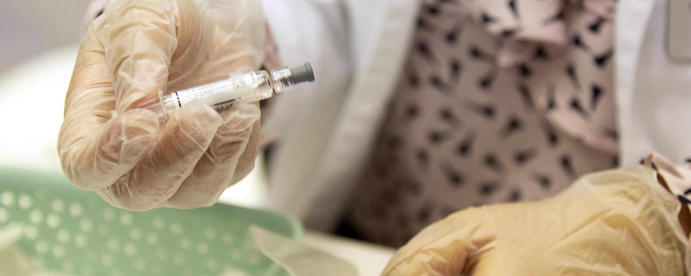 epa07949161 A staff member of the Boston Public Health Commission Medical prepares needles for flu vaccine dose during an open clinic at Boston City Hall in Boston, Massachusetts, USA 25 October 2019. The BPHC and Mayor Walsh urge residents to obtain a seasonal flu vaccination in an effort to prevent the spread of influenza.  EPA/CJ GUNTHER