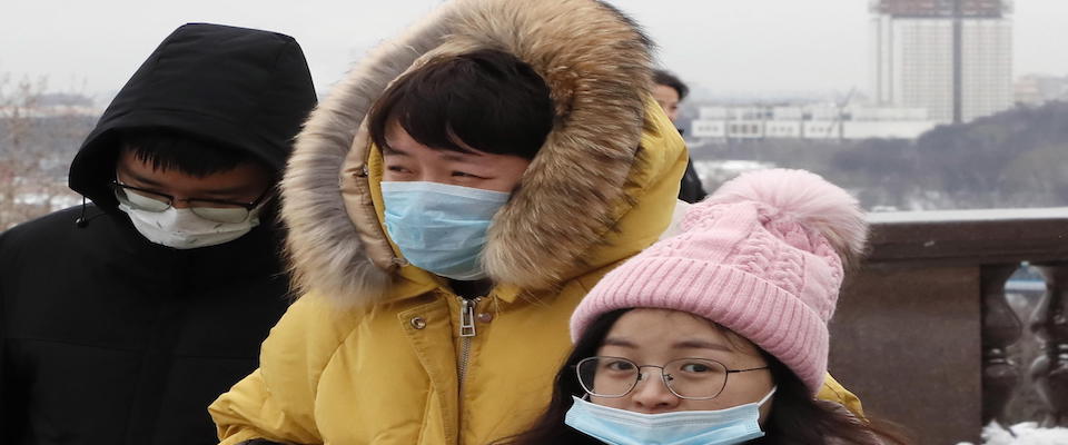 epa08158823 Chinese tourists wearing medical protection masks walk at the Vorobyovy Gory (Sparrow Hills) park in Moscow, Russia, 24 January 2020. All passenger flights to Moscow from China’s Wuhan were suspended on 24 January over coronavirus fears. The outbreak of coronavirus has so far claimed 26 lives and infected more than 800 others, according to media reports. The virus has so far spread to the USA, Thailand, South Korea, Japan, Singapore and Taiwan.  EPA/MAXIM SHIPENKOV