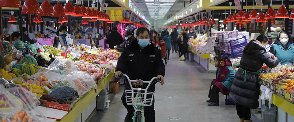 epa08208371 A Chinese man rides a bicycle at a market in Beijing, China, 10 February 2020. China’s Consumer Price Index (CPI) rose 5.4 percent year-on-year in January 2020. The hike was mainly driven by the effect of Chinese Spring Festival holiday and the coronavirus pneumonia epidemic, according to the National Bureau of Statistics (NBS).  EPA/WU HONG