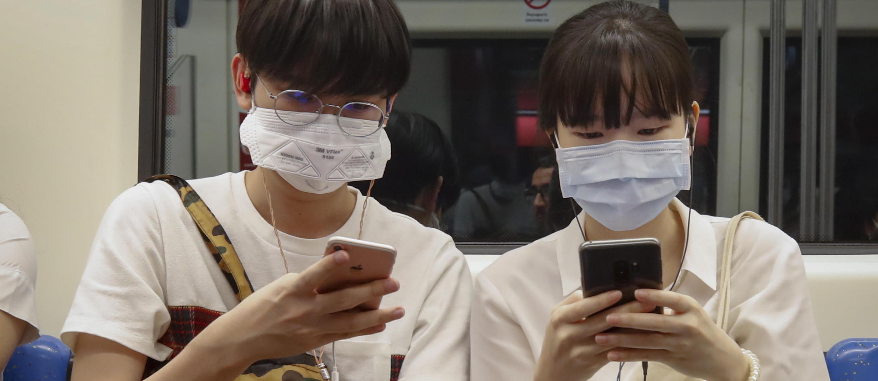 epa08248843 Commuters wearing protective face masks ride the underground or MRT (Metropolitan Rapid Transit) in Bangkok, Thailand, 26 February 2020. Thailand’s Health Ministry is stepping up efforts to contain the spread of the novel coronavirus or COVID-19 after it reported three new cases of on 26 February, bringing the total number of infected people to 40. The Health Ministry is asking people to avoid unnecessary travel to ‘At-risk countries’ which include China, Macau, Hong Kong, Taiwan, South Korea, Singapore, Italy, Iran and Japan.  EPA/DIEGO AZUBEL