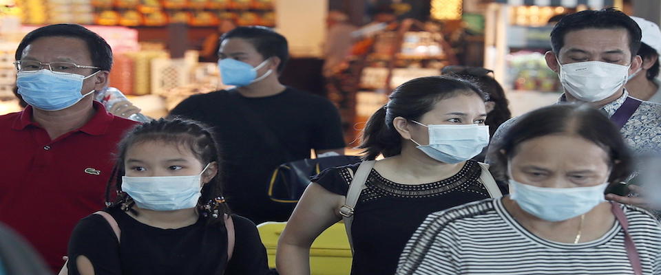 epa08201925 Passengers wearing protective masks walk at Ngurah Rai International Airport in Bali, Indonesia, 08 February 2020. 61 stranded Chinese tourists in Bali have been evacuated by a charter flights on 08 February 2020. The Indonesian government on 05 February started to halt flights to and from mainland China to prevent the spread of the novel coronavirus.  EPA/MADE NAGI