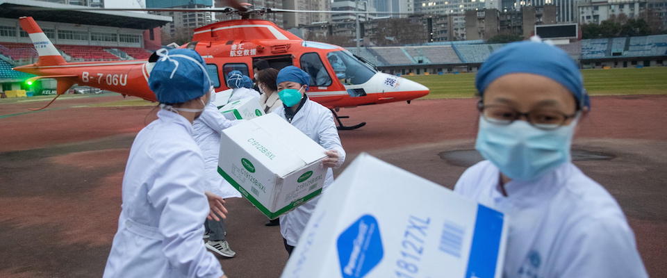 epa08184452 Medical staff of Concorde hospital transfer medical supplies from a helicopter in Wuhan, Hubei Province, China, 01 February 2020. Hospitals in Wuhan and other parts of China are facing a shortage of protective masks, clothing and medical supplies as the novel coronavirus outbreak claimed so far 259 lives and infected close to 12,000 people worldwide.  EPA/YFC CHINA OUT