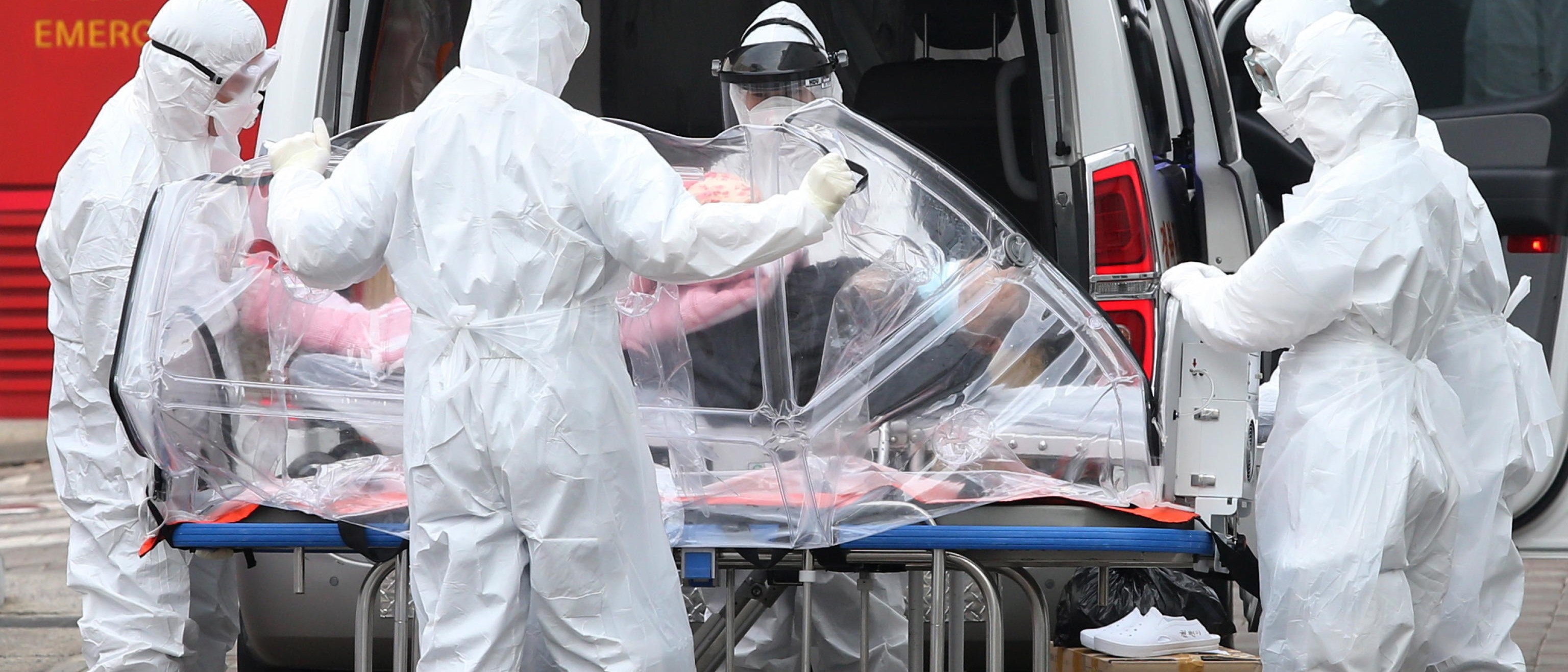 epa08280073 Health workers wearing protective suits prepare an isolation stretcher to move a patient infected with the novel coronavirus Covid-19 disease from an ambulance to a hospital in Seoul, South Korea, 09 March 2020. With over 7,380 confirmed cases of novel coronavirus, South Korea currently accounts for the highest number of infections outside mainland China.  EPA/KIM CHUL-SOO