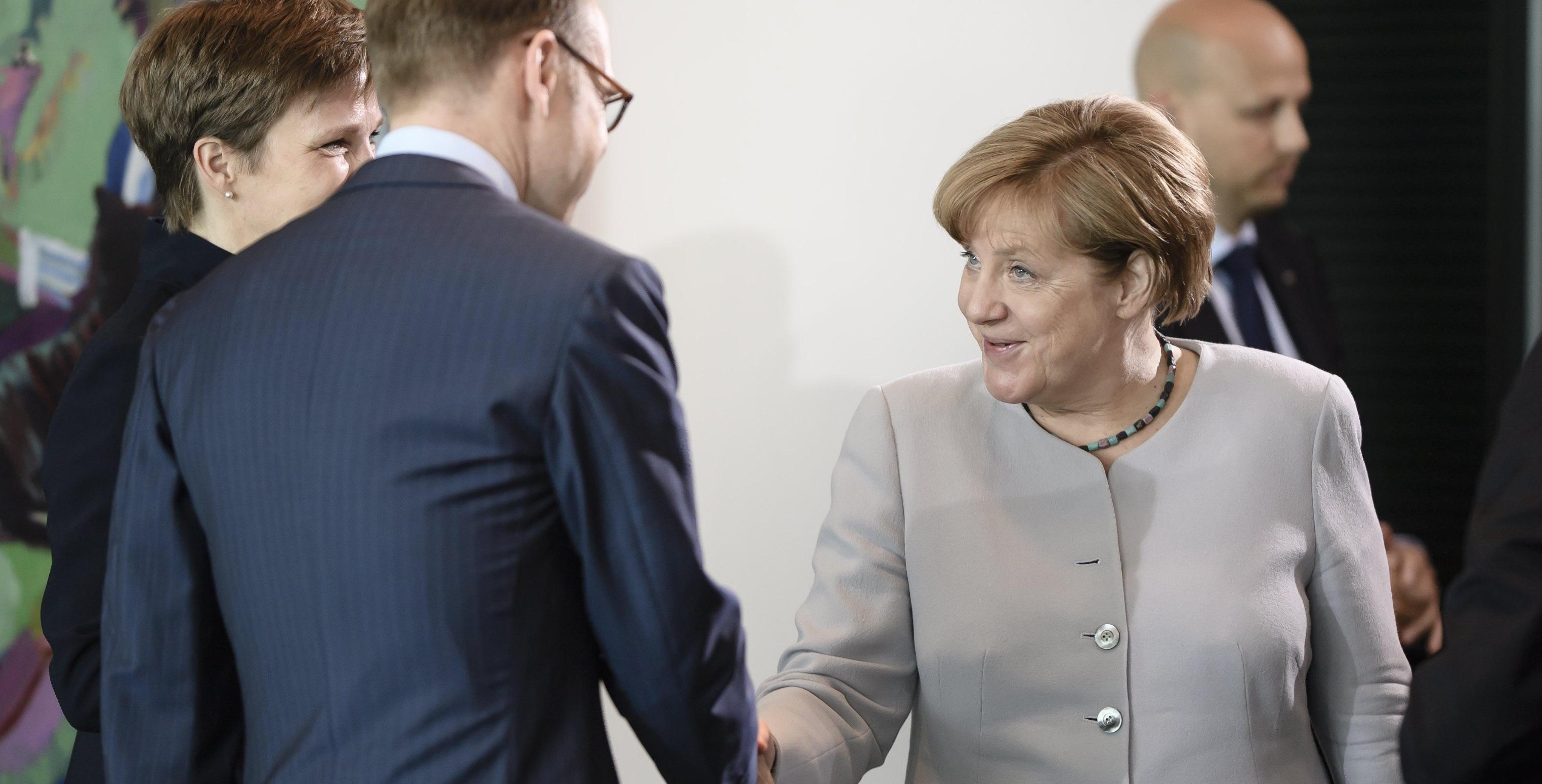 epa06053626 German Bundesbank President Jens Weidmann (2-L) and German Chancellor Angela Merkel (R) shake hands while German Bundesbank vice president Claudia Maria Buch (L) stands next to them at the beginning of the weekly meeting of the German Federal cabinet at the Chancellery in Berlin, Germany, 28 June 2017. During the 153rd cabinet meeting, the ministers and the Chancellor are expected to discuss, among others, a draft law for the Federal Budget for the Fiscal Year 2018.  EPA/CLEMENS BILAN