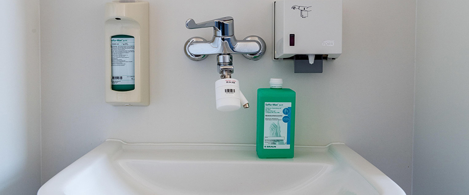 epa08323576 A sink with disinfectant and soap in the building of the former orthopedic clinic in Halle, Germany, 26 March 2020. The hospitals in the city of Halle are expected to start operating a so-called ‘Corona Clinic’ on 26 March 2020. Up to 50 beds would be available after a gradual opening, the city said. The beds shall primarily be used for people showing mild Covid-19 symptoms who either cannot take care of themselves at home or live with relatives belinging to a risk group.  EPA/JENS SCHLUETER