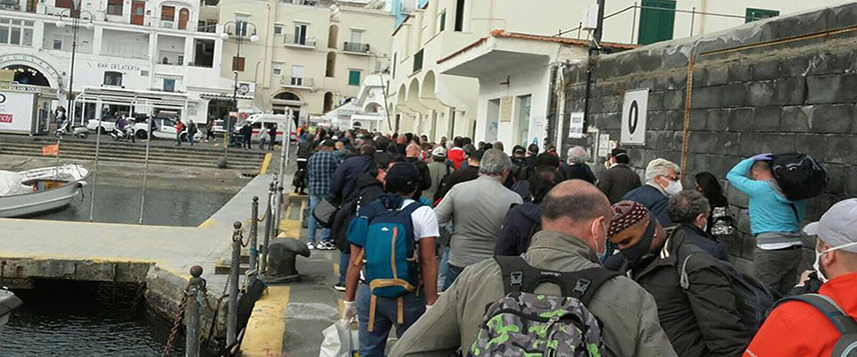 Large crowds in the port of the island of Capri at the arrival of the first ships of the morning during the Covid-19 emergency, near Naples, Italy, 11 May 2020.  ANSA / Giuseppe Catuogno