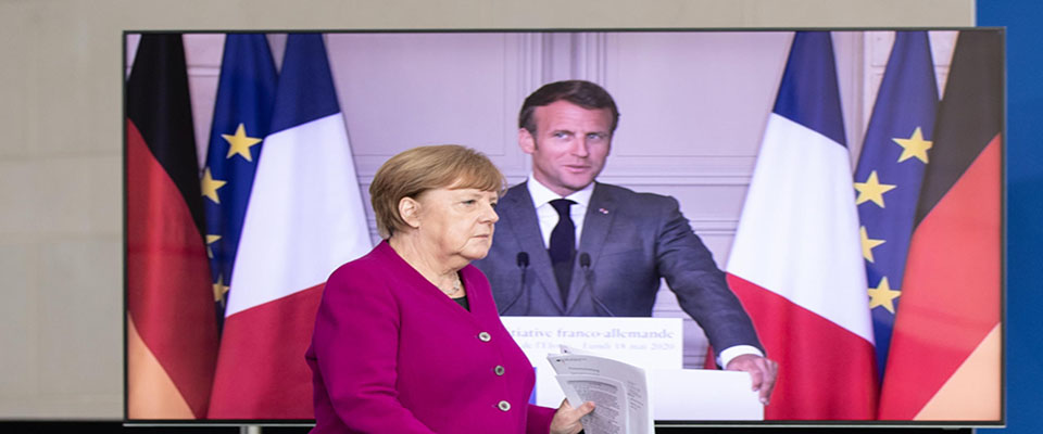 epa08430501 French President Emmanuel Macron (L) and German Chancellor Angela Merkel (R) during a joint video press conference at the Chancellery in Berlin, Germany, 18 May 2020. France and Germany discussed Europeâ€™s economic recovery plans to respond to the virus crisis. Germany and France propose a 500-billion-euro European programme to support the economic recovery following the coronavirus crisis.  EPA/ANDREAS GORA / POOL