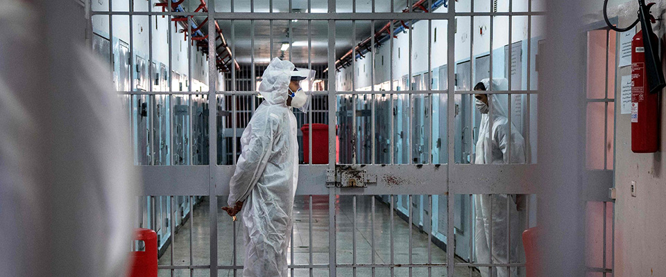 Prison wardens, wearing personal protective equipment due to the COVID-19 pandemic, keeps watch at the Oukacha prison in Casablanca on May 18, 2020. (Photo by FADEL SENNA / AFP)