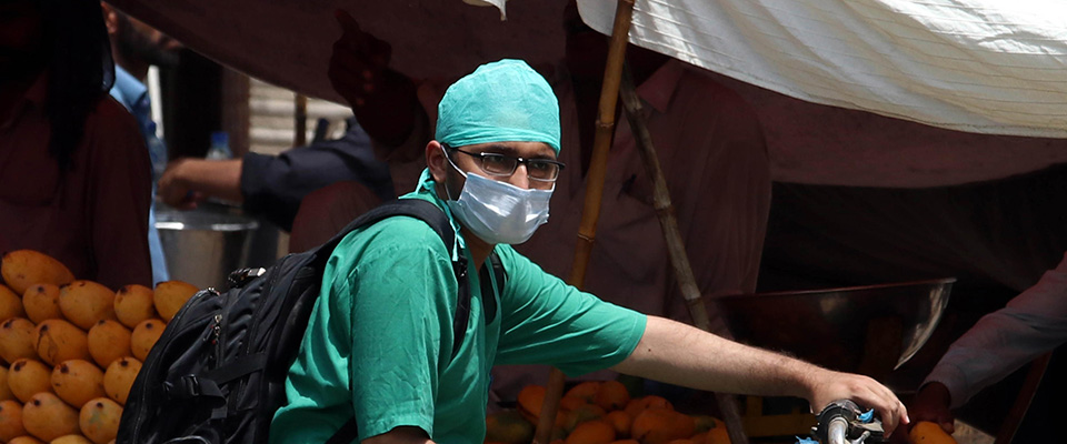 epa08470859 A hospital staff wears a protective face mask during partial lockdown in Karachi, Pakistan, 07 June 2020. Countries around the world have started to ease COVID-19 lock-down restrictions in an effort to restart their economies and help people in their daily routines after the outbreak of coronavirus pandemic  EPA/SHAHZAIB AKBER