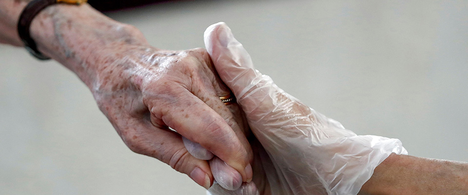 epa08472810 Cristina (R), wearing gloves, takes her mother Marisa’s hand at Orpea Aravaca retirement home, in Madrid, 08 June 2020. Cristina visited her mother in the first day in which the relatives can visit the retirement homes during phase 2 of coronavirus lockdown retirement process. Retirement homes were one of the main COVID-19 sources. In Madrid, some 6,007 retirement homes residents died since 08 March amid coronavirus pandemic.  EPA/MARISCAL  ATTENTION: This Image is part of a PHOTO SET