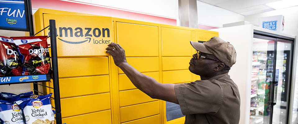 epa08432594 A United Parcel Service (UPS) driver picks up a parcel at an Amazon locker at a convenience store in Washington, DC, USA, 19 May 2020. Amid the coronavirus COVID-19 pandemic, the US Postal Service, Amazon, FedEx, and UPS have all reported an increase of parcel deliveries. At the same time, first-class mail has dropped significantly, according to media reports.  EPA/MICHAEL REYNOLDS