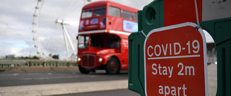 epa08746913 A London bus drives over Westminster Bridge in London, Britain, 15 October 2020. According to news reports the UK government is set to impose further restrictions on London, as Covid -19 infections continue to rise.  According to recent data from the Office for National Statistics (ONS) Covid-19 deaths in England have risen four fold over the last month.  EPA/ANDY RAIN