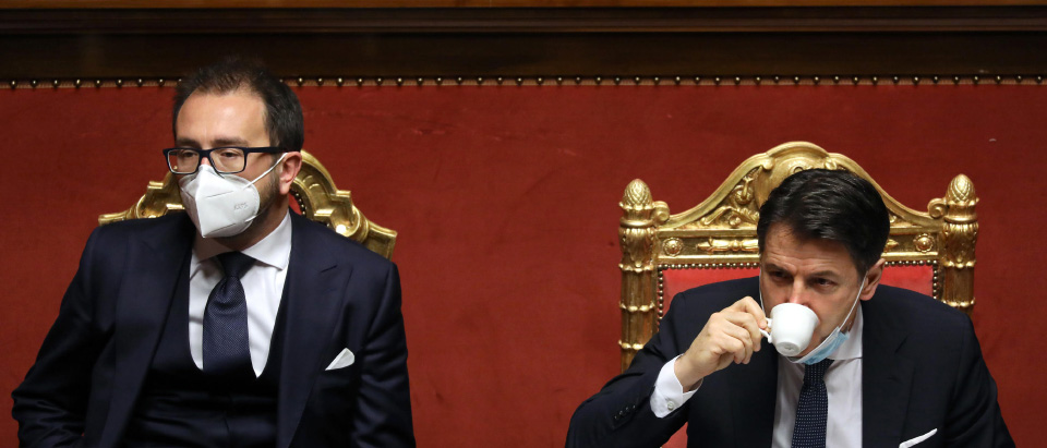 Giuseppe Conte, Italy’s prime minister, right, drinks a coffee speaks flanked by Alfonso Bonafede, ItalyÕs justice minister, during a debate in the Senate in Rome, Italy, on Tuesday, Jan. 19, 2021. Prime Minister Giuseppe Conte waged a charm offensive Tuesday in the Italian Senate ahead of a vote that will decide whether his coalition can survive. Alessia Pierdomenico/Bloomberg/Pool/Ansa