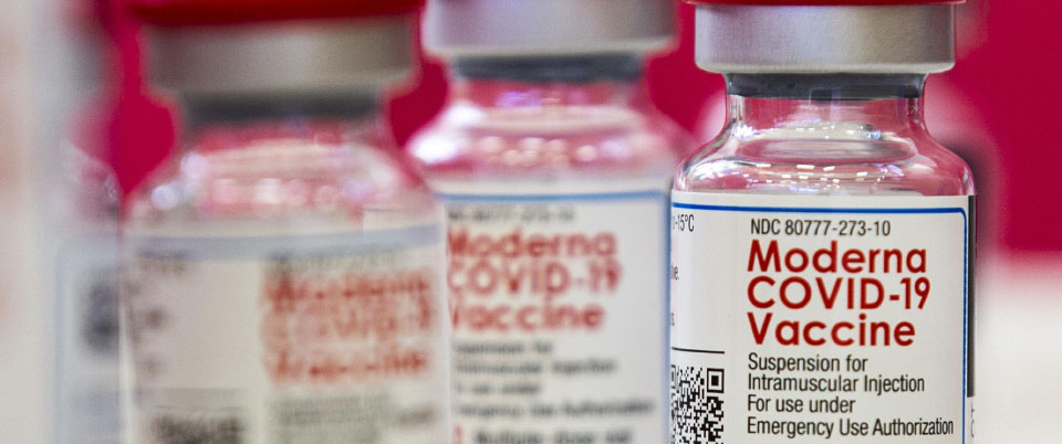 epa08939946 Vials of the Moderna vaccine against COVID 19 are displayed at the Corona High School where people get vaccinated amid the coronavirus pandemic in Corona, Riverside County, East of Los Angeles, California, USA, 15 January 2021.  EPA/ETIENNE LAURENT