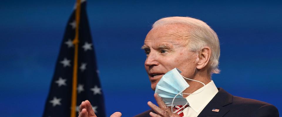 US President-elect Joe Biden shows a face mask as he answers questions about COVID 19 from the press at The Queen in Wilmington, Delaware on November 16, 2020. – US President-elect Joe Biden expressed frustration on November 16, 2020 about Donald Trump’s refusal so far to cooperate on the White House transition process, saying “more people may die” without immediate coordination on fighting the coronavirus pandemic. (Photo by ROBERTO SCHMIDT / AFP)