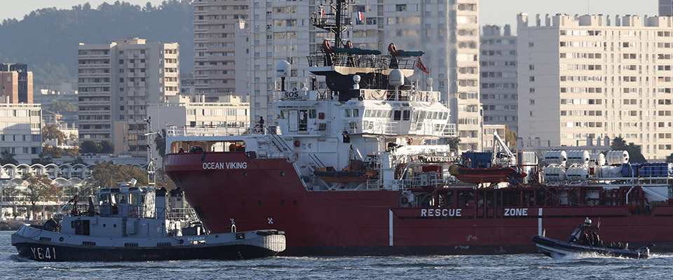 epa10299258 The Ocean Viking rescue ship (C), operated by French maritime-humanitarian organization SOS Mediterranee, enters the harbor escorted by a military boat (L), in Toulon, France, 11 November 2022. SOS Mediterranee on 10 November announced receiving the green light by French authorities to allow the over 230 migrants onboard to disembark in Toulon. The vessel spent weeks at sea after rescuing migrants during several operations throughout October.  EPA/GUILLAUME HORCAJUELO