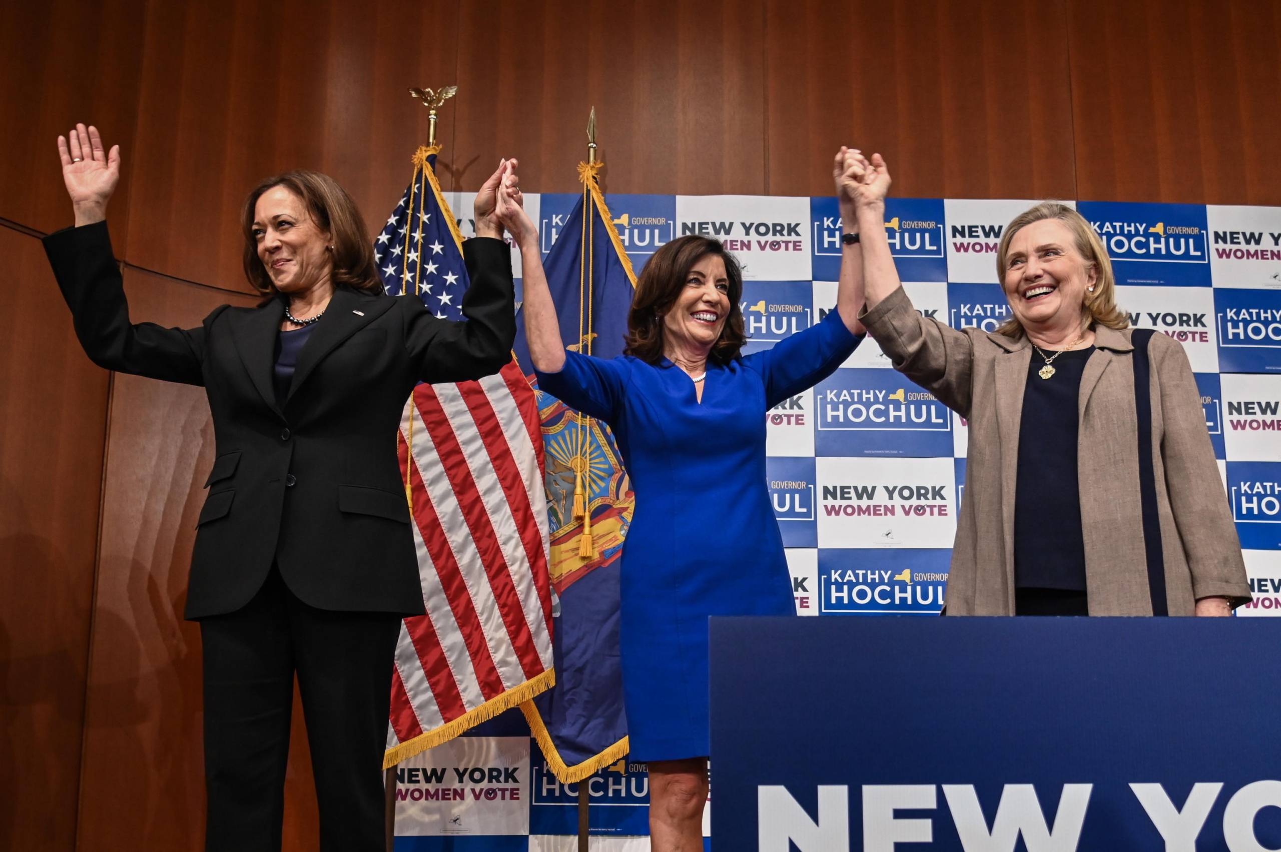 epa10285146 (L-R) US Vice President Kamala Harris, New York Governor Kathy Hochul, and Former United States Secretary of State Hillary Clinton join hands while on stage during an event at Barnard College, in New York, New York, USA, 03 November 2022.  EPA/Anthony Behar / POOL